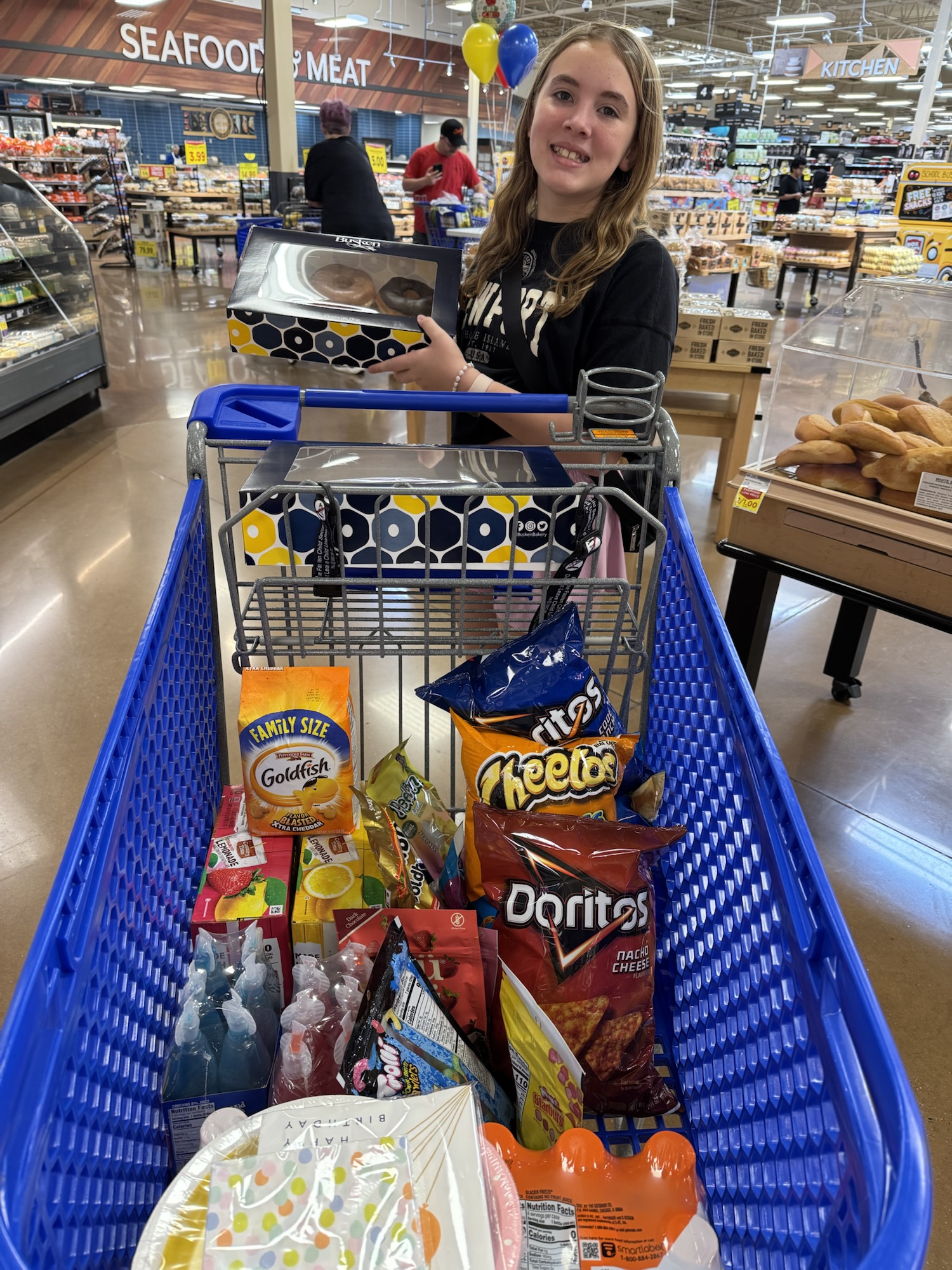 Paige shopping at Kroger for party snacks