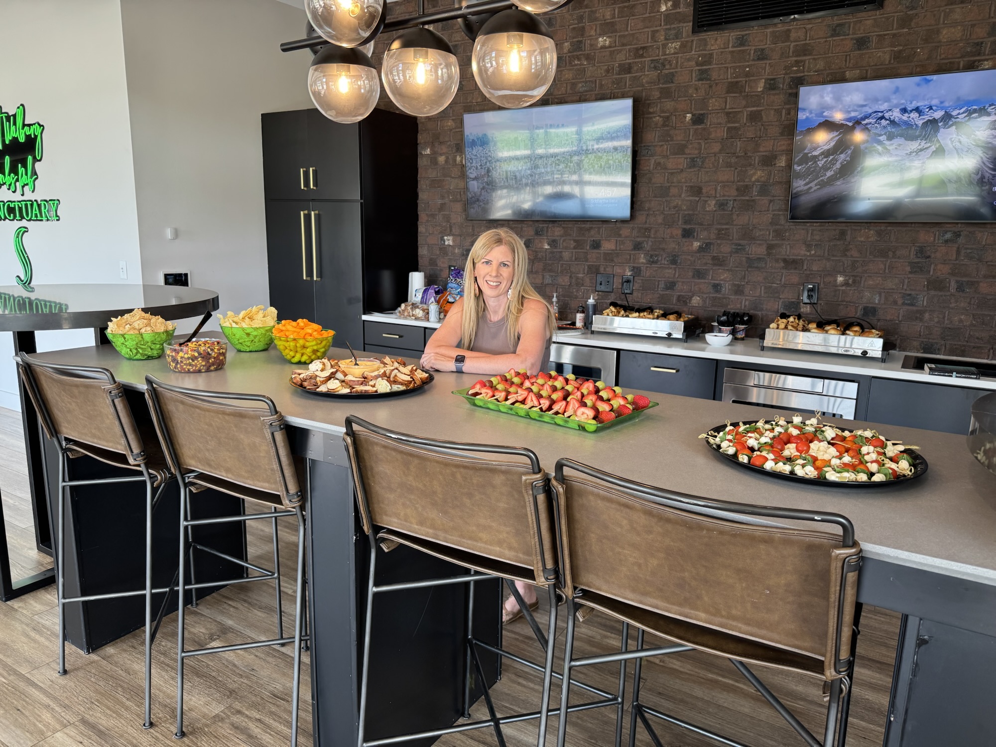 Abby standing with party food and candy set up